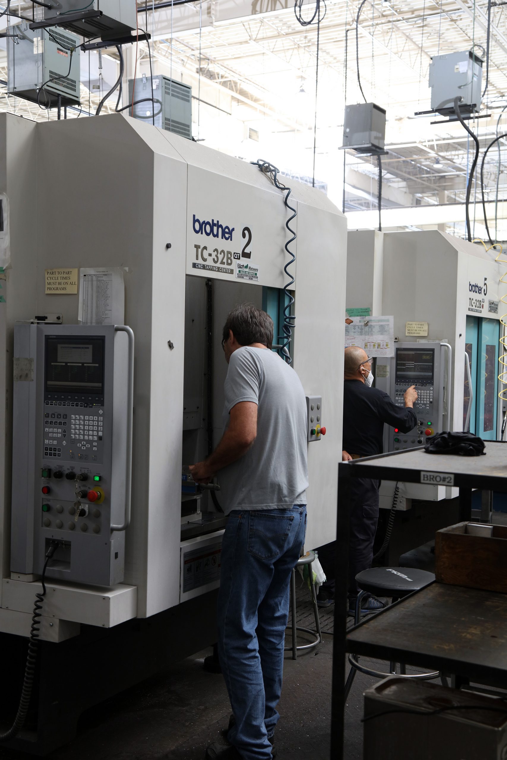 an employee looks inside a Brother TC-32B machining centre