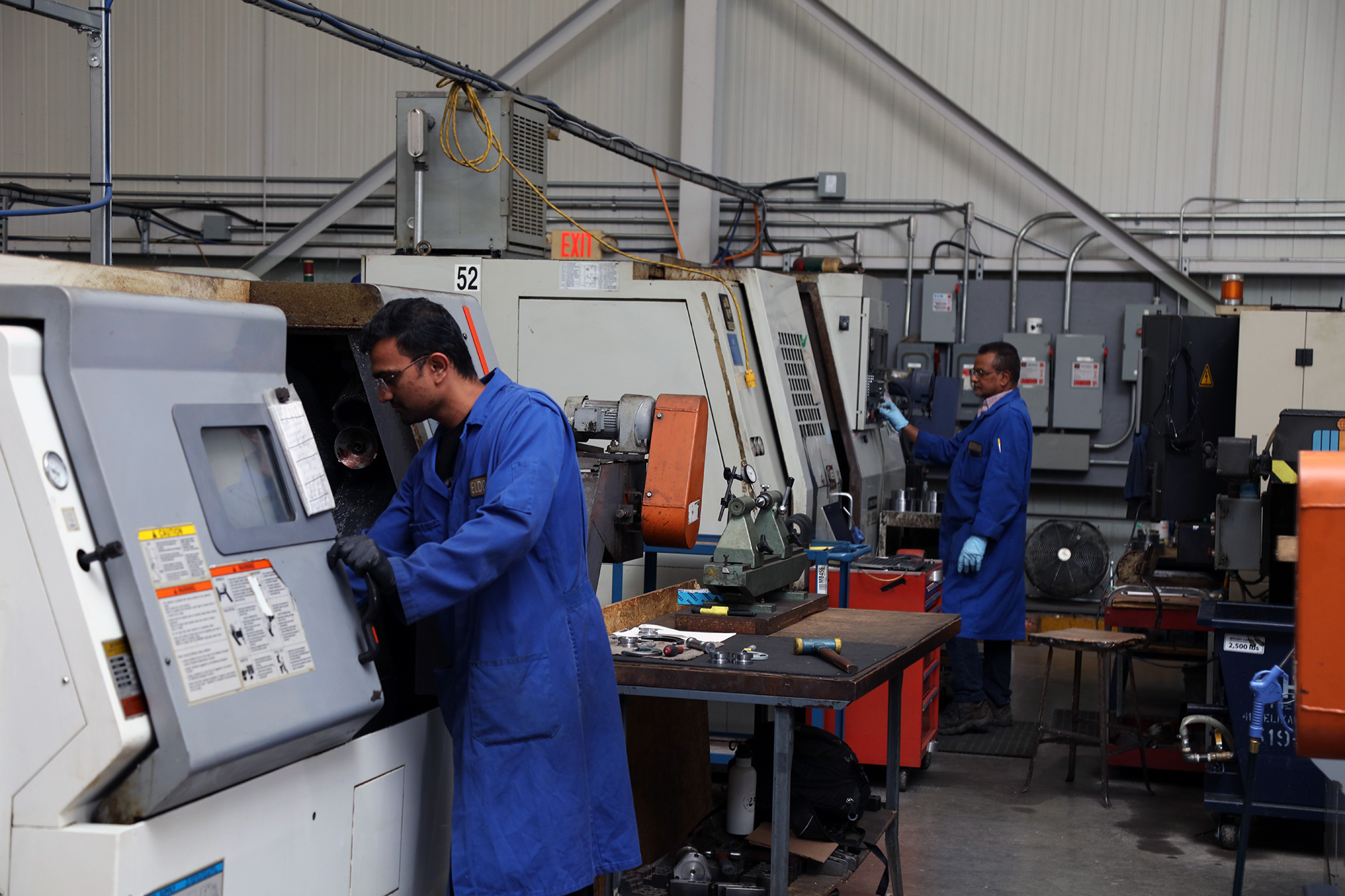 two employees operating separate machine centres