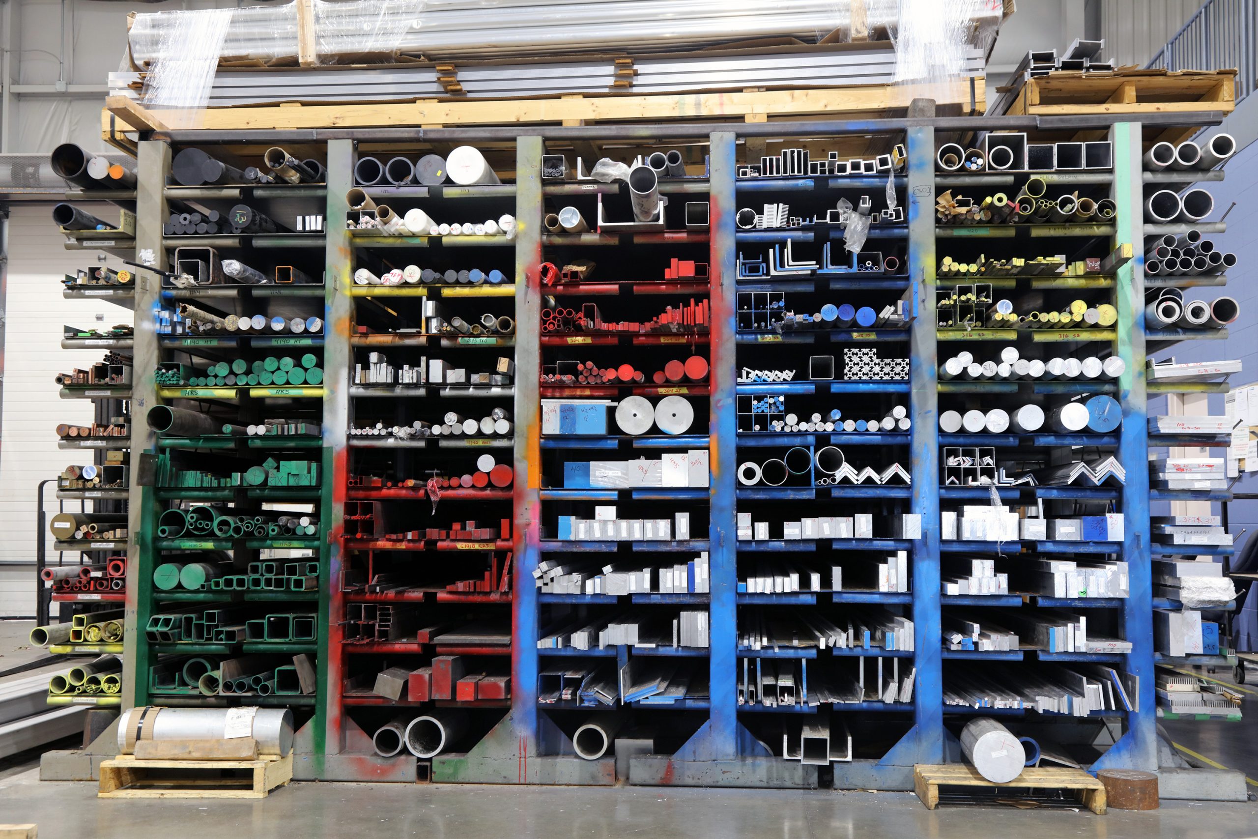 shelving units containing various raw materials that are colour coded based on their type