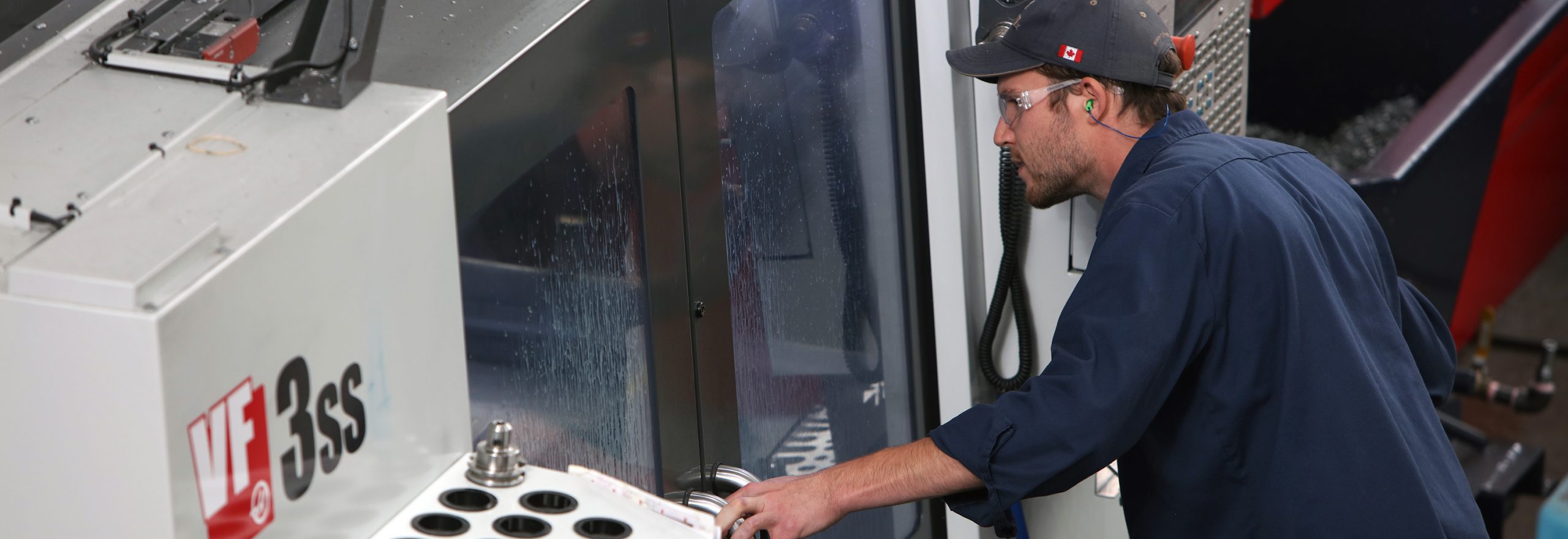 an employee looks inside a VF3SS vertical machining centre
