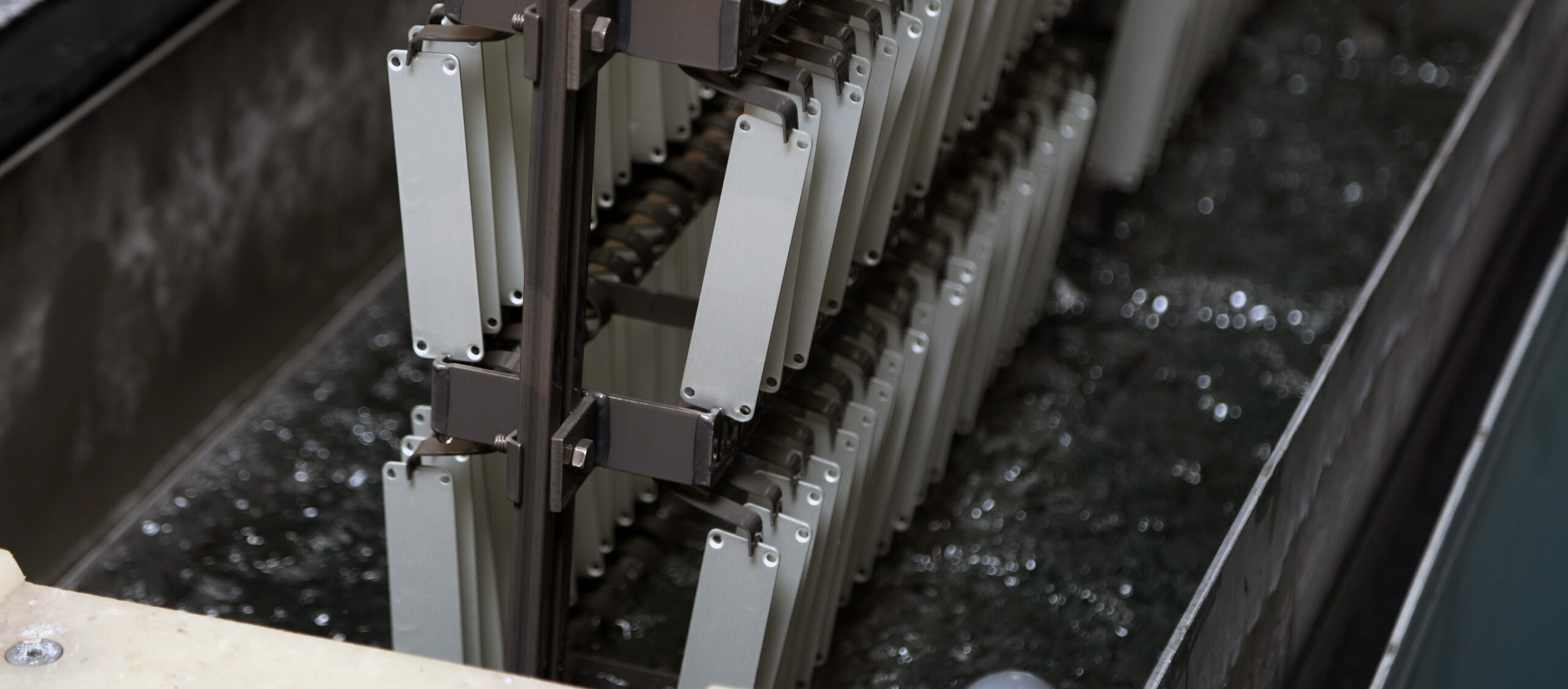 racks of metal going through the anodizing process