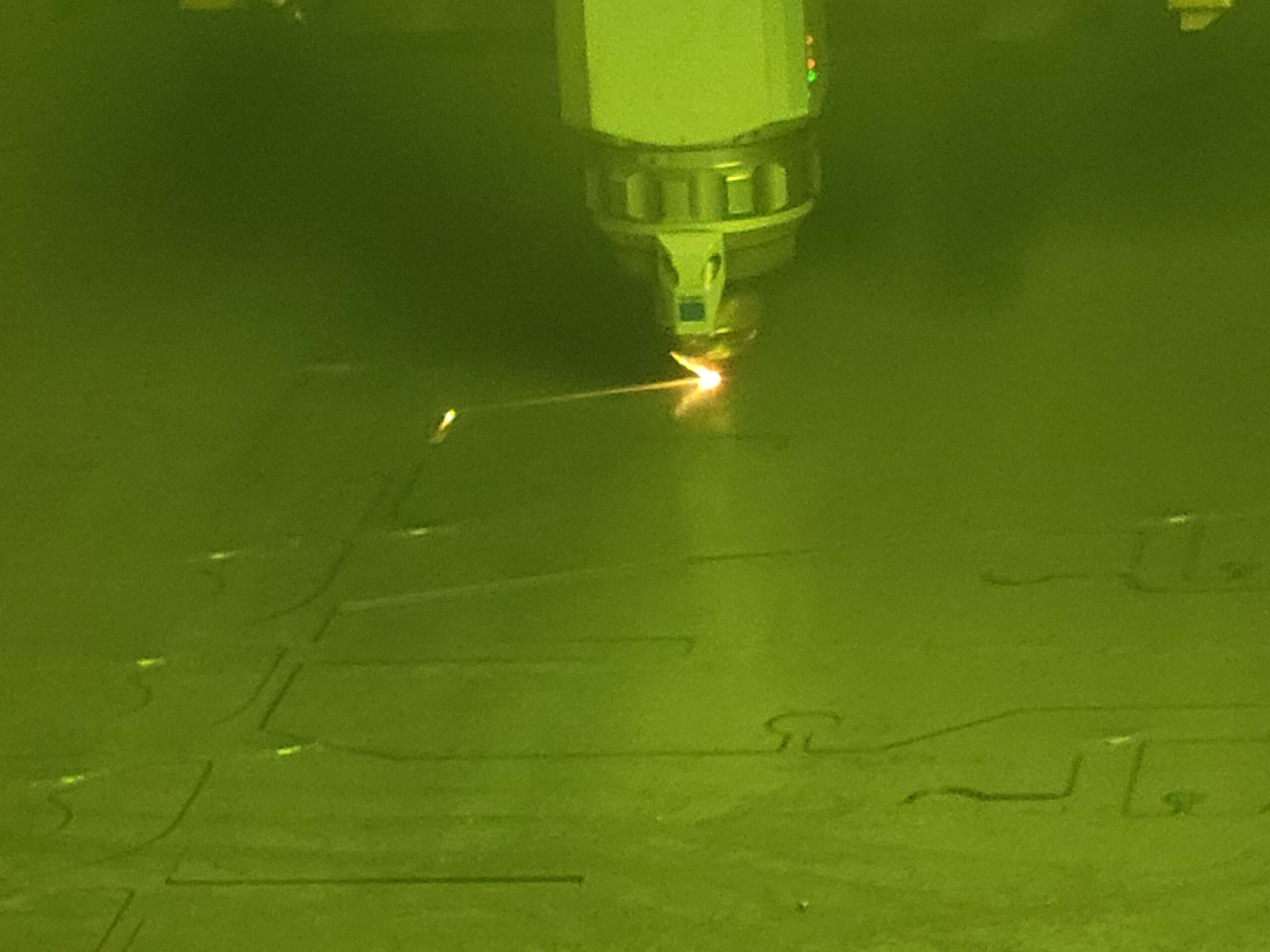 A laser cutting into a sheet of metal